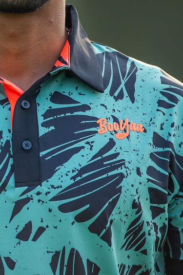 Bundu's Golf Polo, aqua, navy and orange golf shirt, on-model front detail