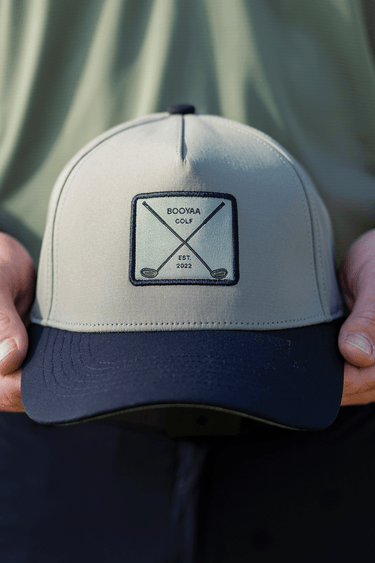 BooYaa Premium Golf Cap - STEALTH, gray and navy cap, front detail in hands