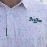 Rosebay Golf Polo, white golf shirt with fine pink and blue floral print, on-model front detail