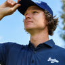 Golfer in the Oxford Navy Vintage golf polo and Navy Classic golf hat, looking up